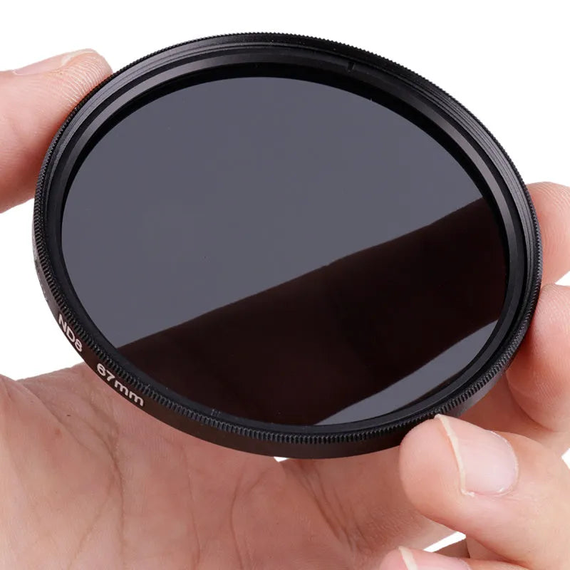 ND8 neutral density camera filter with silver aviation aluminium frame for lens attachment.