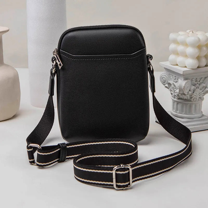 Solid colour PU leather mobile phone crossbody bag showing compact size and shoulder strap.