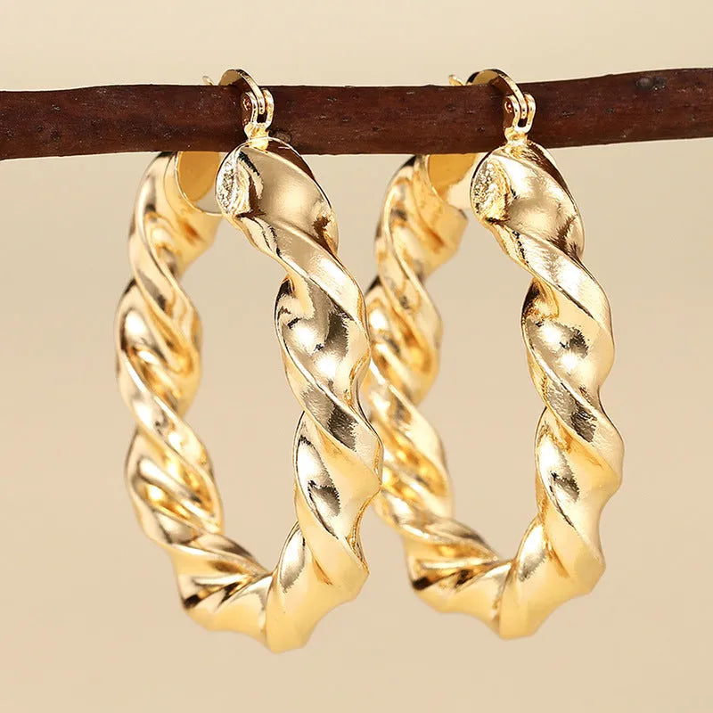 Women's geometric drop-shaped ear clips with ring and line elements in copper electroplated finish