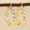 Women's geometric drop-shaped ear clips with ring and line elements in copper electroplated finish