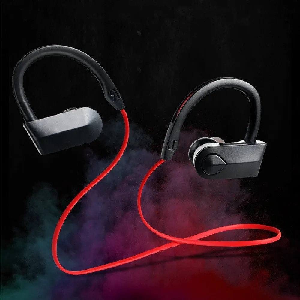 Black wireless neckband Bluetooth earphones with earbuds and a USB charging cable on a grey background.