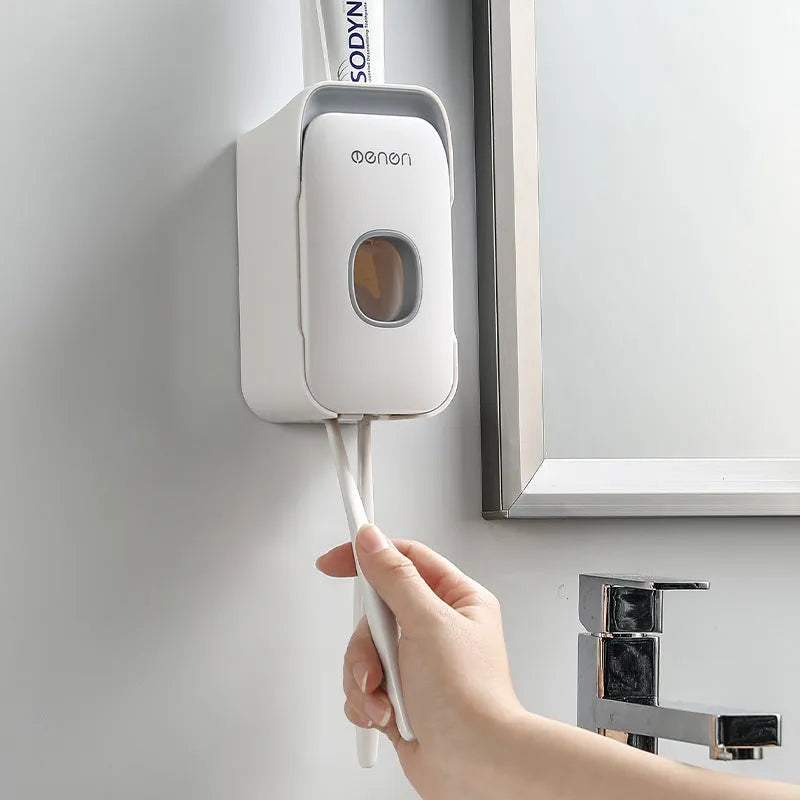 Automatic touchless toothpaste dispenser with digital LCD display mounted on a bathroom wall