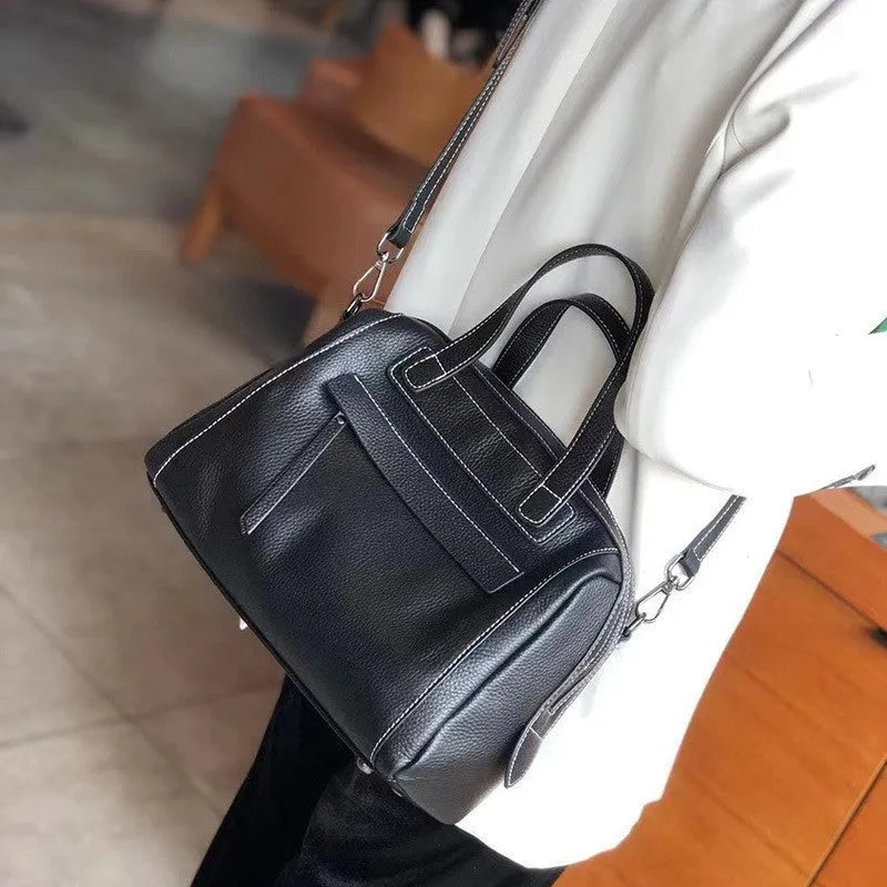 Genuine leather messenger bag with litchi pattern texture in a horizontal square shape.