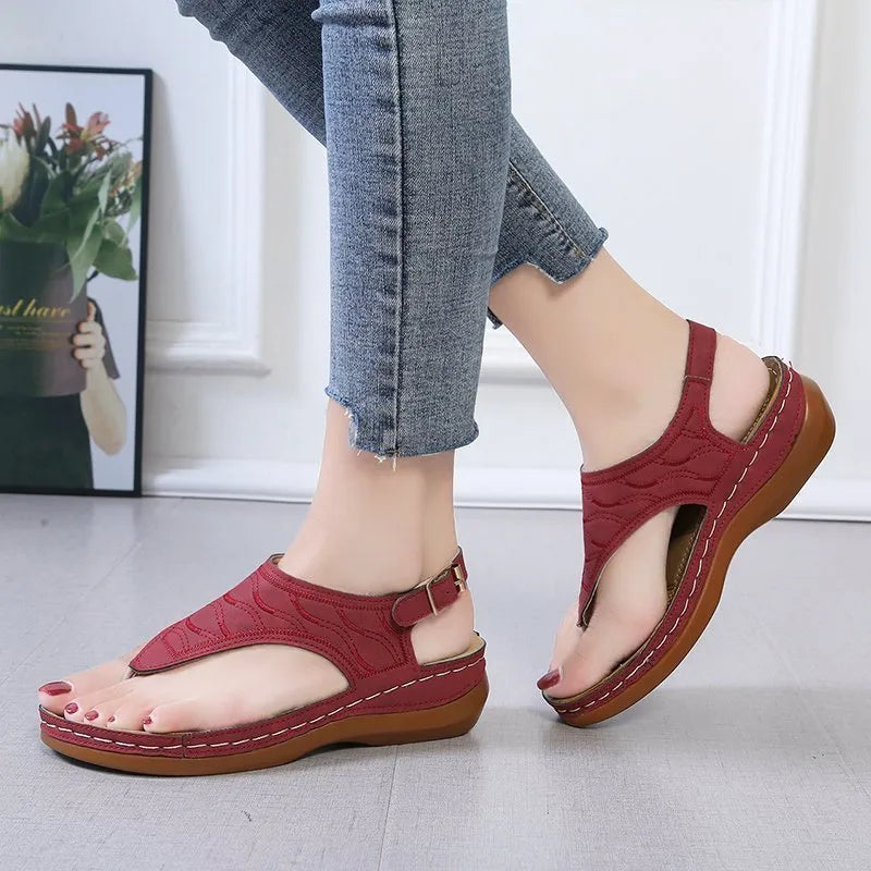Women's casual wedge heel sandals with an adjustable buckle strap in red.