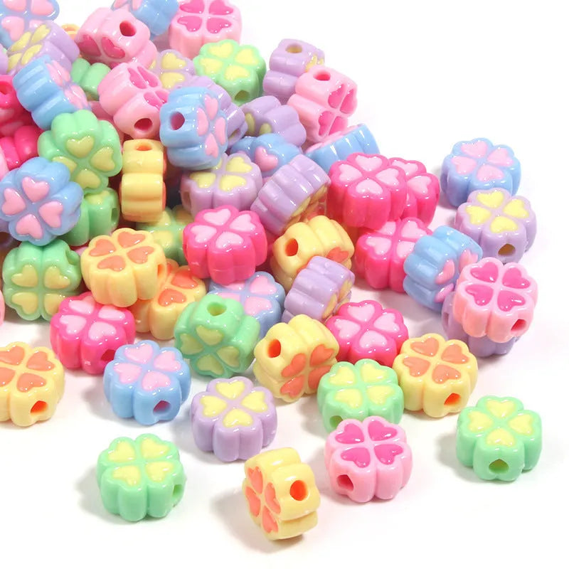15mm acrylic clover-shaped beads with love pattern in multiple pastel colours including rose red, pink, yellow, green, blue, and purple