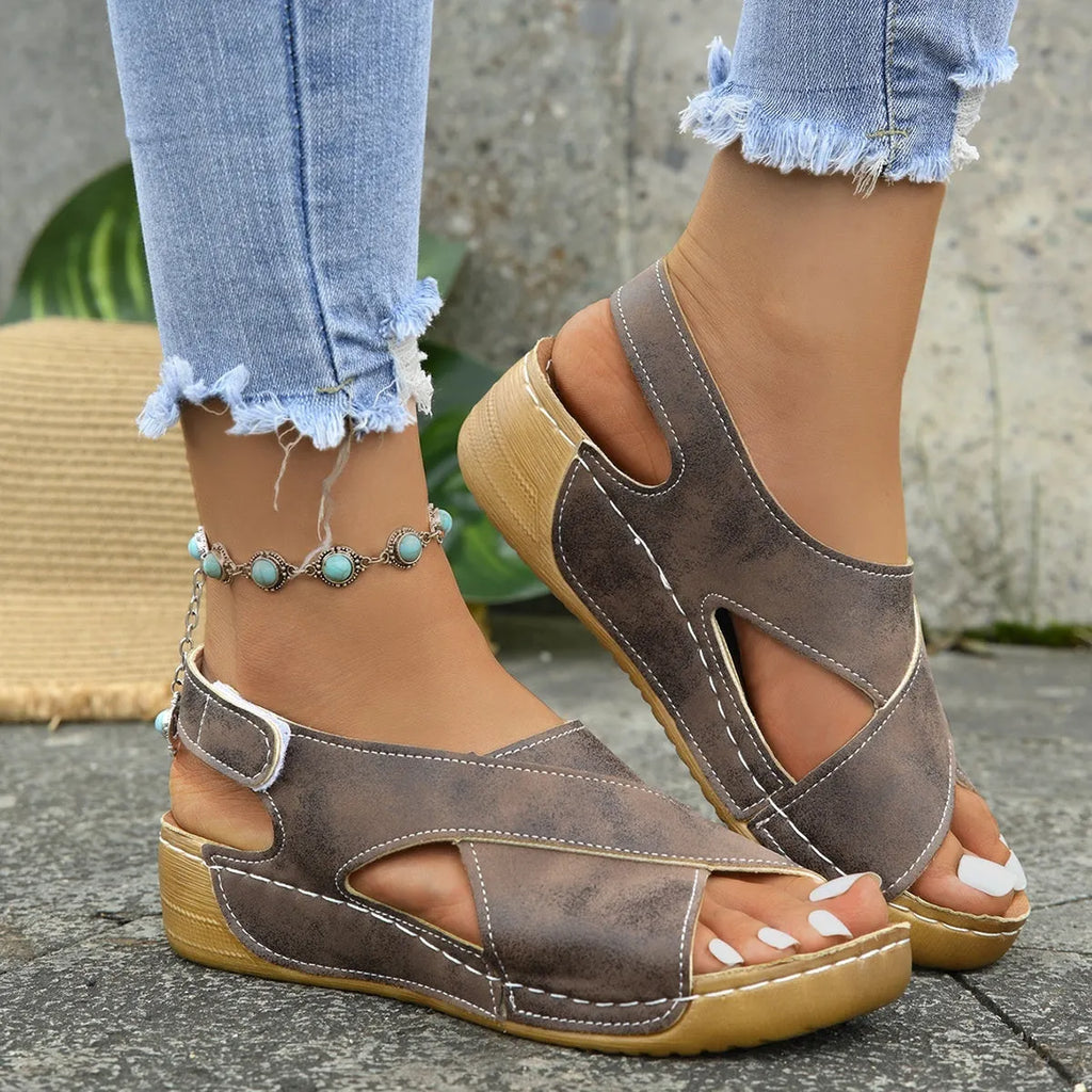 Women's brown Roman platform sandals with an open toe and Velcro strap closure on a rubber sole.