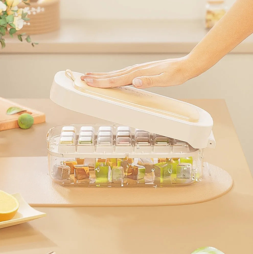Yellow high-capacity ice cube tray with leverage handle and stored ice shovel.