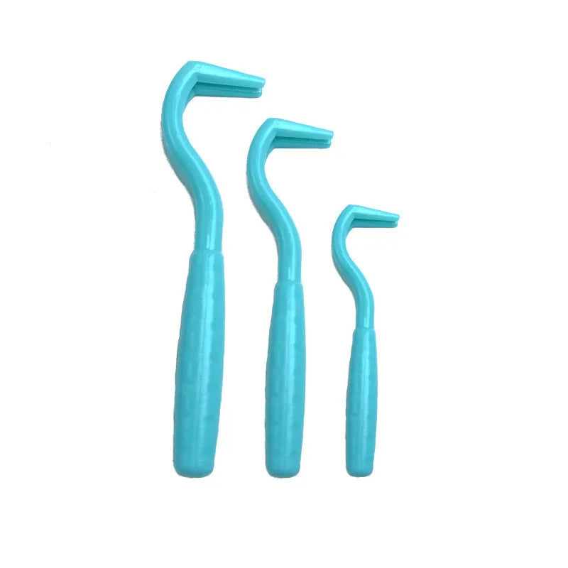 Three plastic tick hooks for dogs in various colours showing curved removal ends