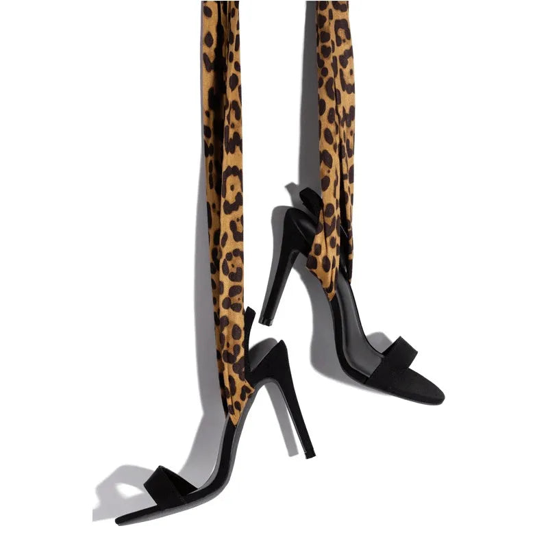 Light brown leopard print women's high-heeled sandals with Roman cross straps and a thin high heel.
