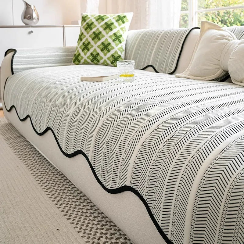 Special-shaped straight row patterned sofa cover in ice silk fabric on a grey sofa