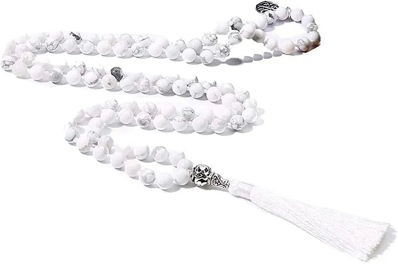 Handmade knotted beaded necklace with geometric stone pendant in natural colours.