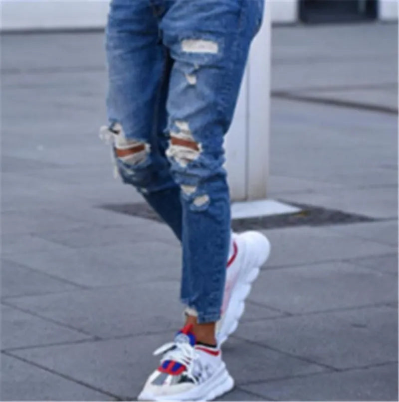 Men's distressed jeans in a deep blue wash on a size chart