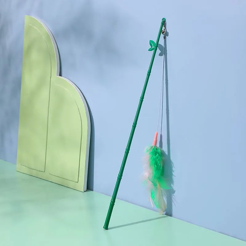 Green interactive cat feather wand toy with bell and feather attachments for indoor play