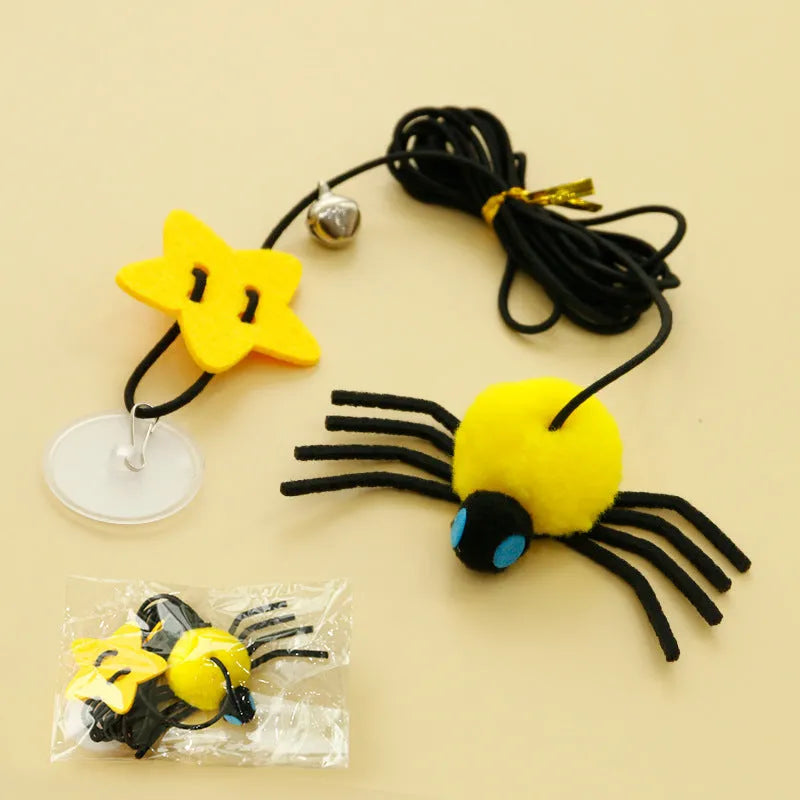 Red and yellow cat hanging door toy with elastic rope, feathers, a bell, and a spider attachment.
