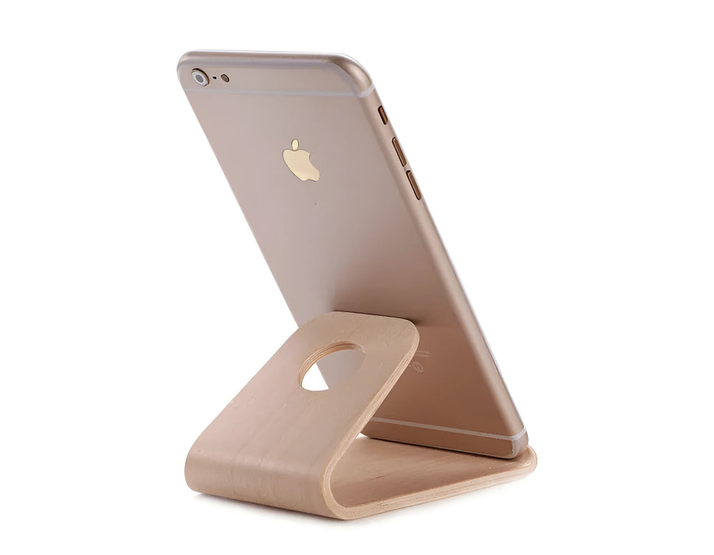 A wooden phone stand in a bracket design holding an iPhone, shown in walnut and white maple finishes.
