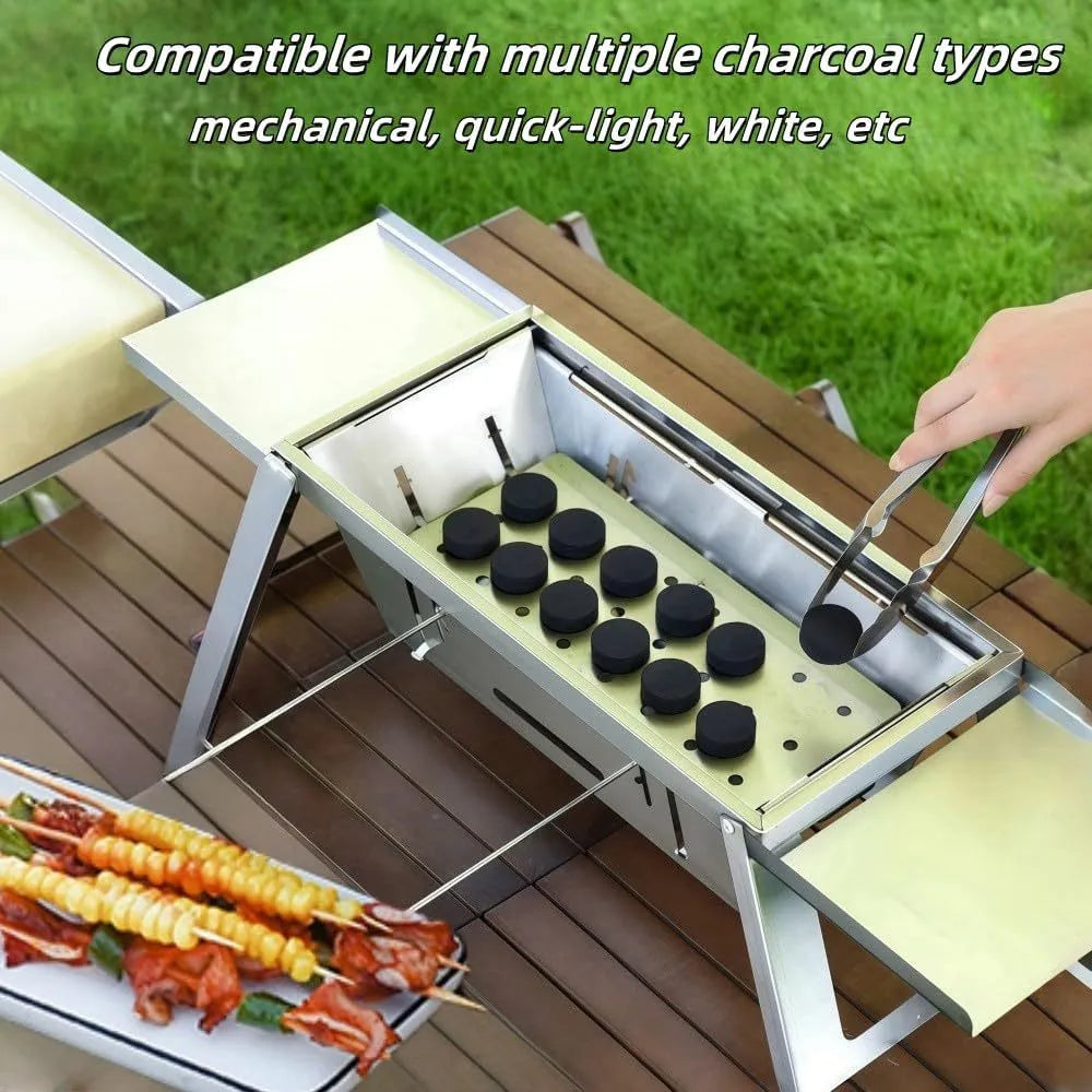 Small folding portable charcoal grill shown set up for an outdoor barbecue.