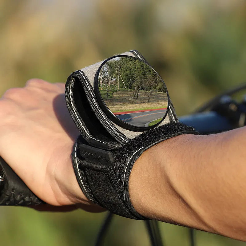 Black nylon cycling rear-view mirror fixture mounted on bicycle handlebars.