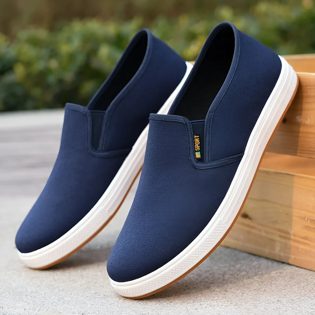 Men's black and blue low-top canvas slip-on shoes with round toe and composite soles