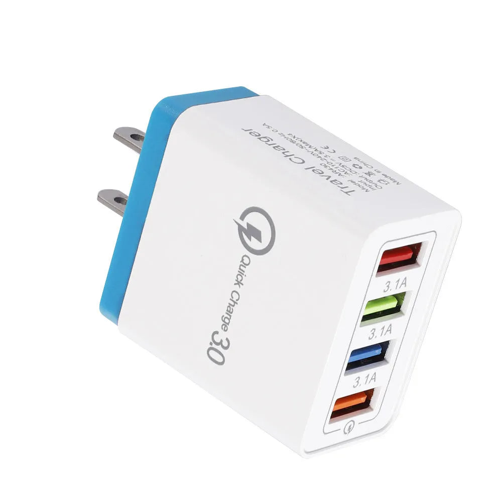 Compact 4-port USB mobile phone charger in multiple colours, shown plugged into a UK wall socket.