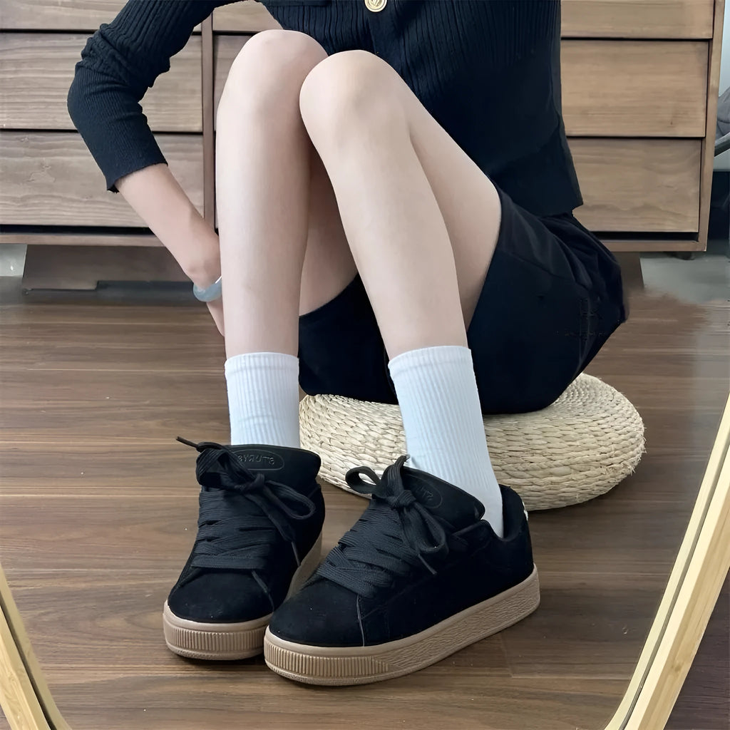 Black retro low-top sneakers with lace-up front, round toe, and waterproof platform sole