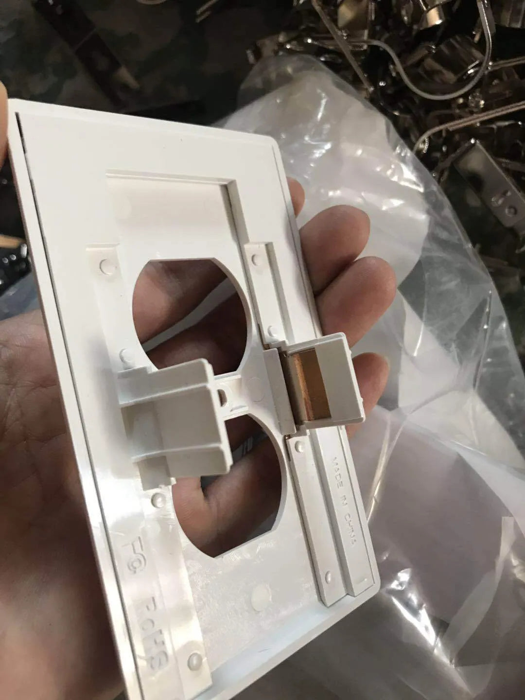 White plastic socket induction LED night light plugged into a wall outlet