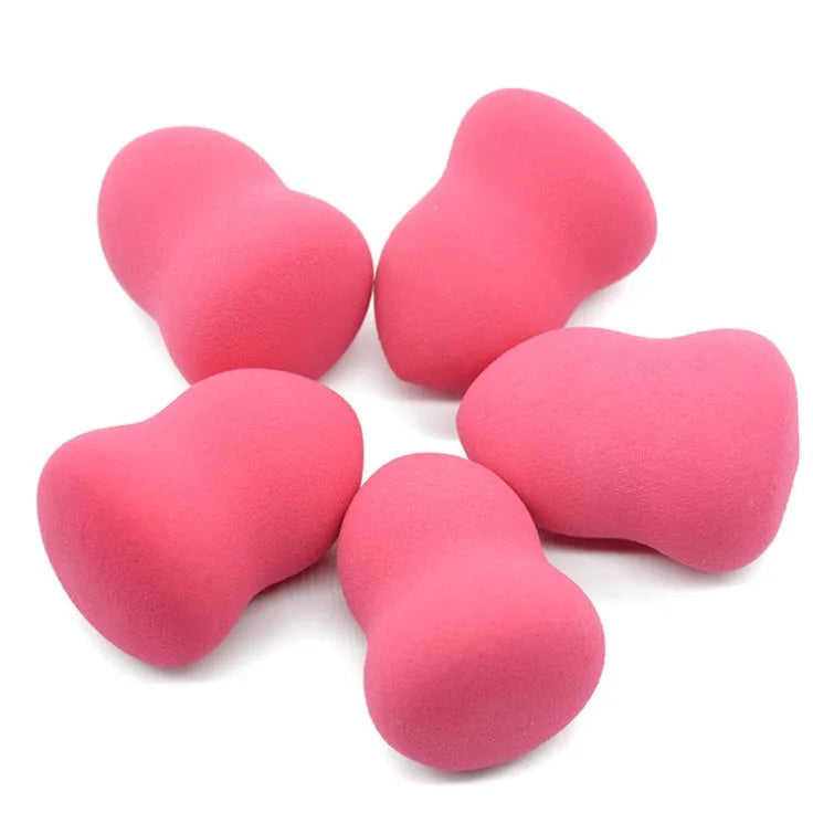 Pink makeup foundation sponge with chiselled edges for blending, shown next to a ruler showing 4cm width.