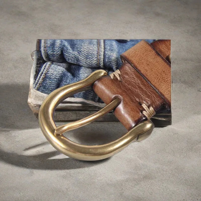 Men's black cattlehide leather belt with a copper pin buckle shown on a flat surface.