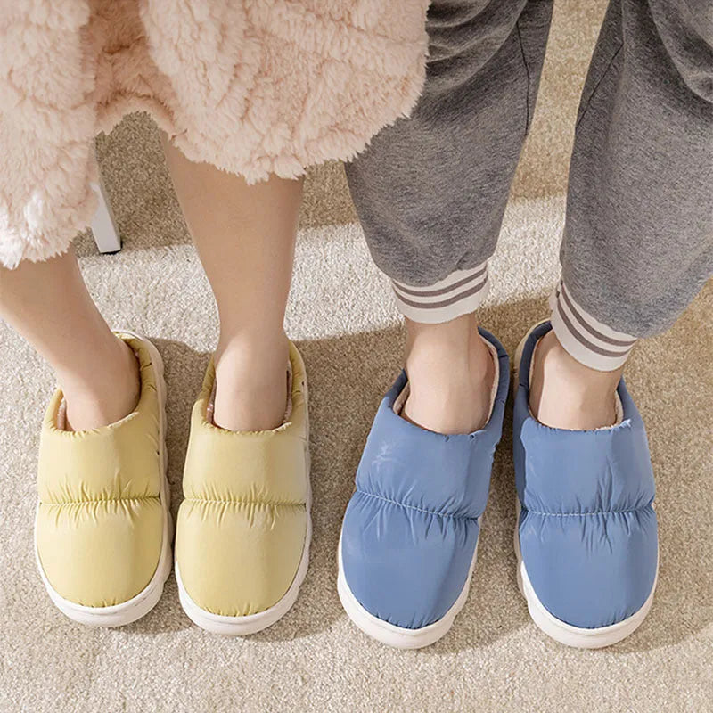 Blue down cotton slippers with a thick rubber sole and plush lining for indoor winter wear.