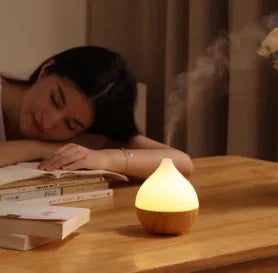 Wood grain finish vase-shaped aroma diffuser with 100ml water tank capacity.