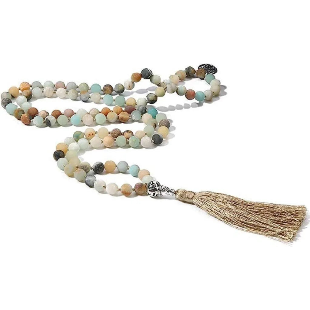 Handmade knotted beaded necklace with geometric stone pendant in natural colours.