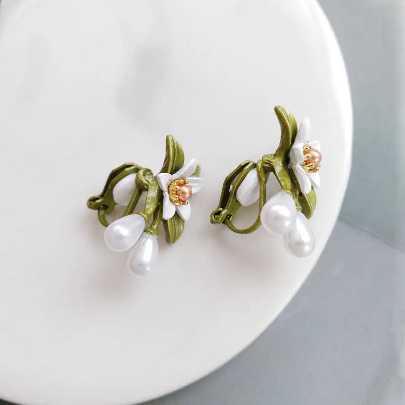 Alloy flower earrings for women, showing stud and clip styles with contrasting colour floral design.