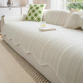 Special-shaped straight row patterned sofa cover in ice silk fabric on a grey sofa