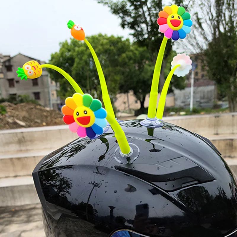 Yellow silicone sunflower helmet decoration with suction cup attachment swinging from motorcycle helmet