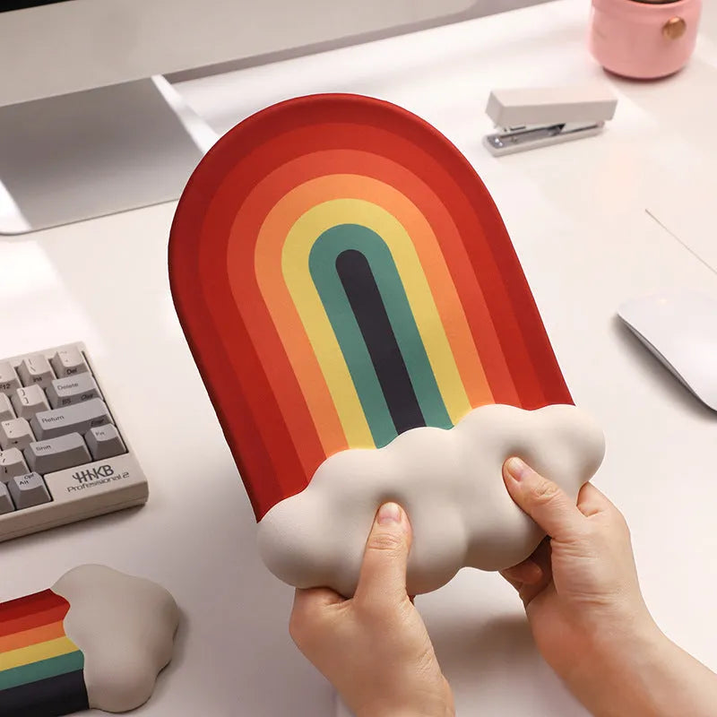 Silicone gel wrist rest mouse pad and keyboard support set in Cloud Rainbow design on a desk