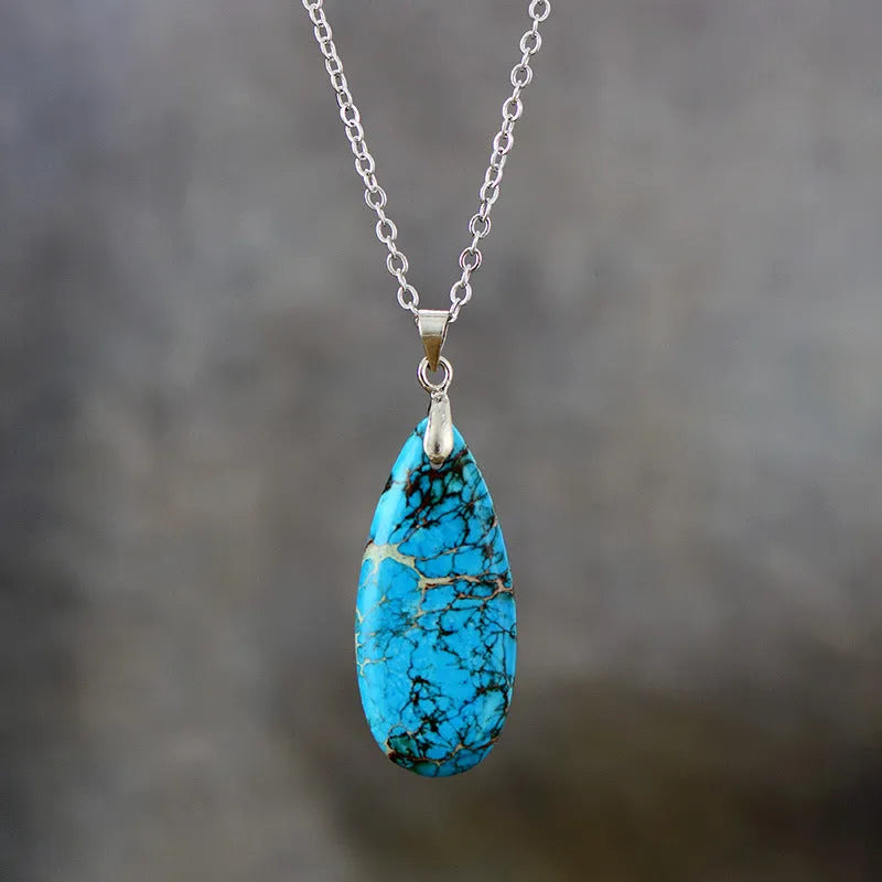Water drop shaped emperor stone jade pendant on an 18K gold plated chain necklace.