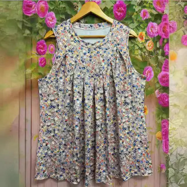 A black plus-size sleeveless vest with a floral print, shown on a hanger, featuring a round neck and loose fit.