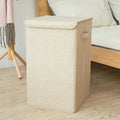 Foldable cotton linen storage basket in grey, shown in a modern room holding clothes and books.