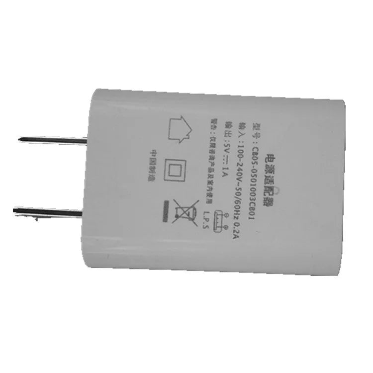 Thin white USB wall charger with CE and FCC markings showing universal voltage input and 5V 1A output