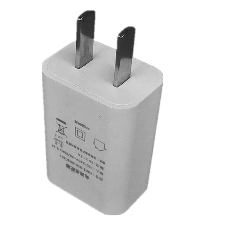 Thin white USB wall charger with CE and FCC markings showing universal voltage input and 5V 1A output