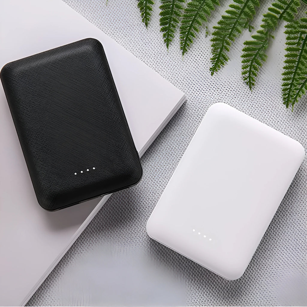 Black ultra-thin 10,000mAh power bank with multiple USB ports on a white background