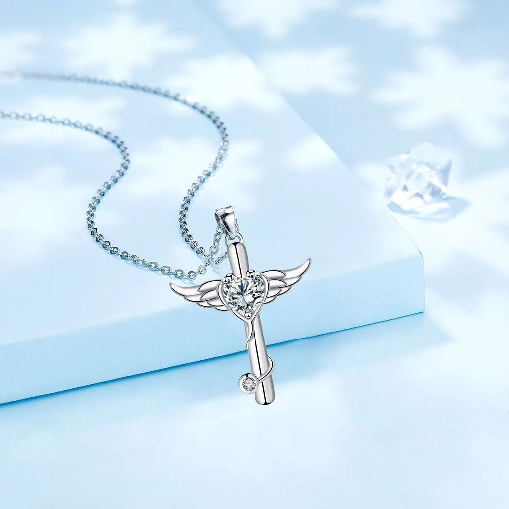Close-up of a copper stethoscope cross pendant with wing details on a chain, available in Red Diamond or White Diamond finish.