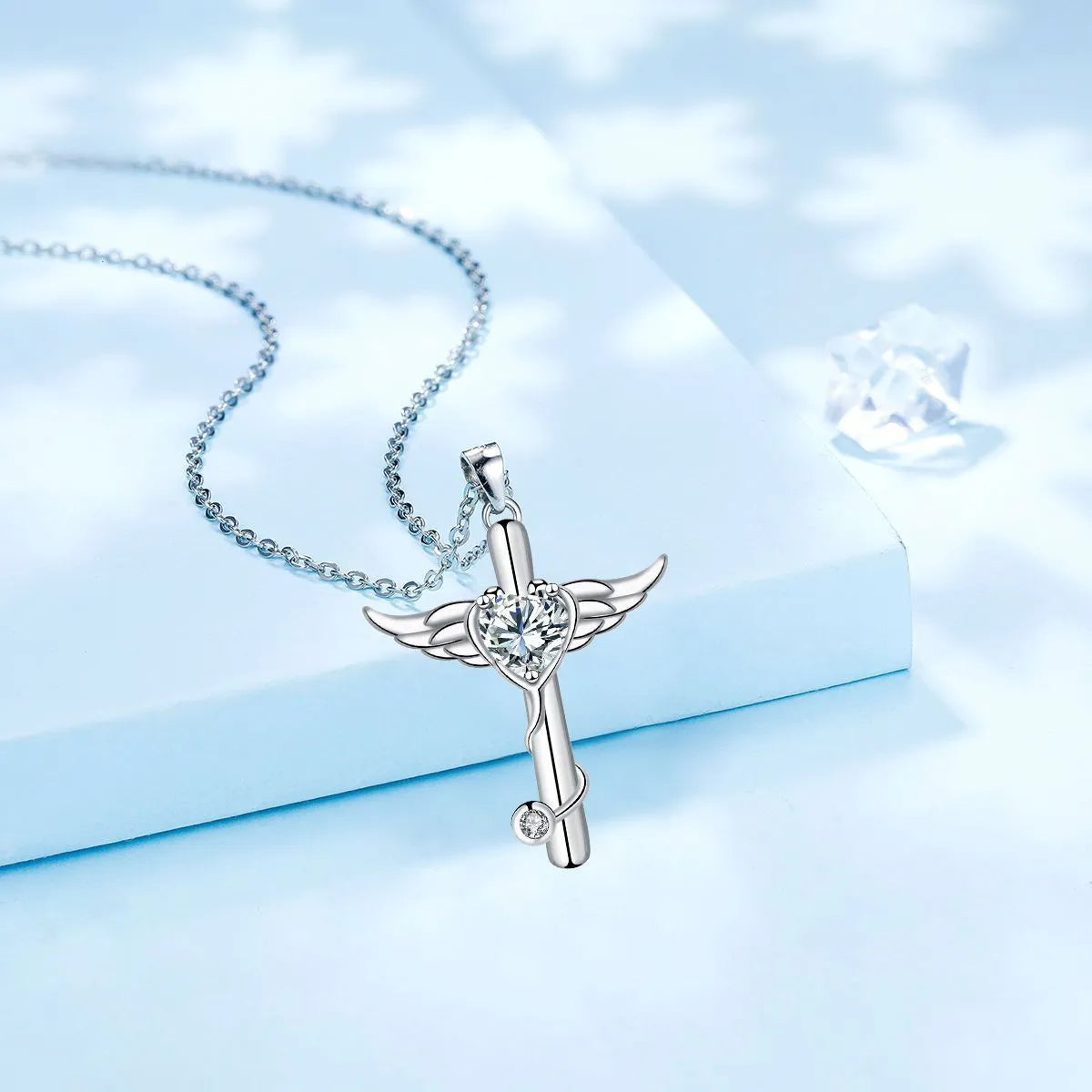 Close-up of a copper stethoscope cross pendant with wing details on a chain, available in Red Diamond or White Diamond finish.