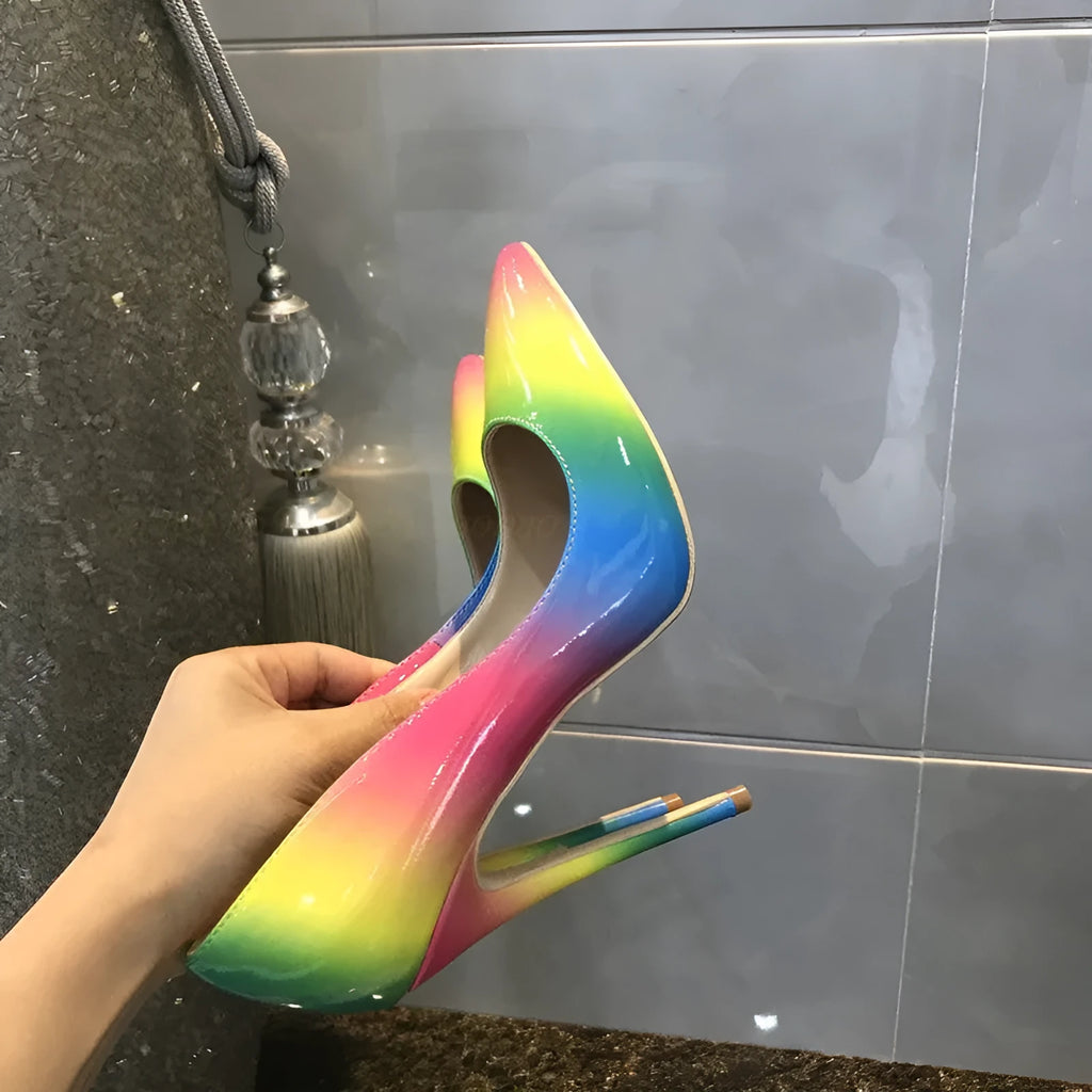 Rainbow patent leather pointed toe stiletto heels with thin ultra-high heel on white background