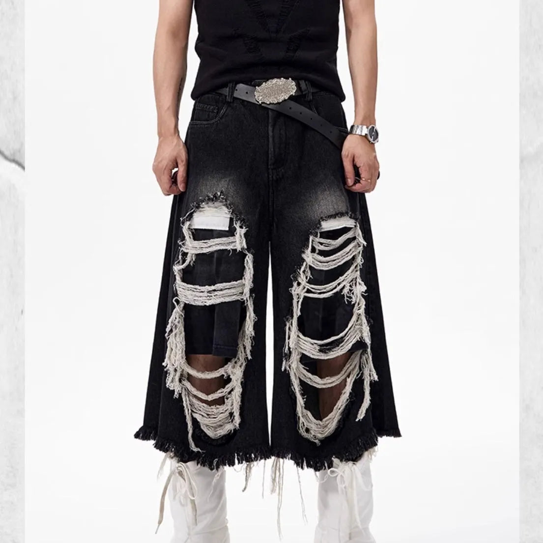 Black cropped wide leg jeans with ripped patch detailing and mid-high waist