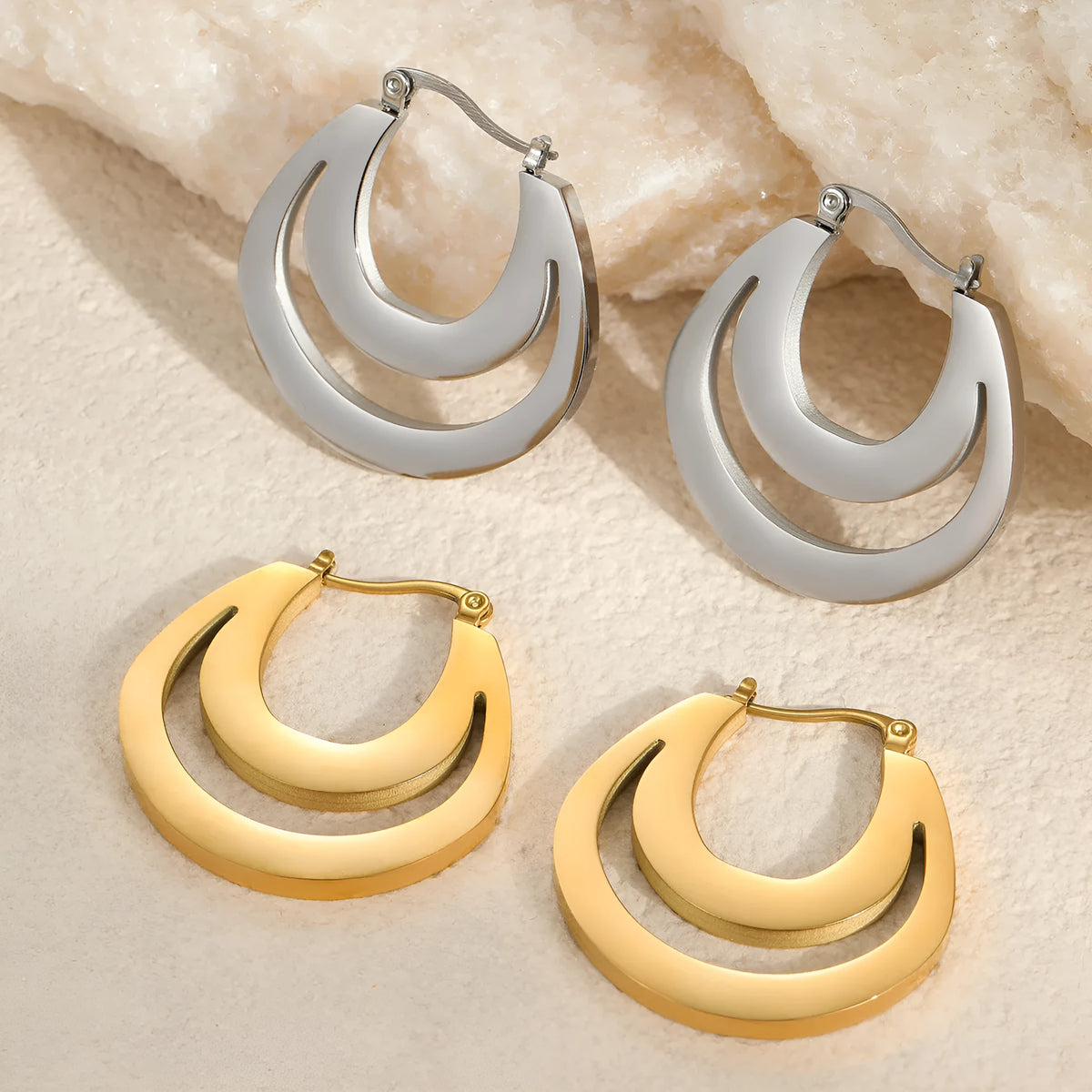 Geometric French earrings with round ring design in 18K gold-plated stainless steel, shown in gold and steel silver finishes.