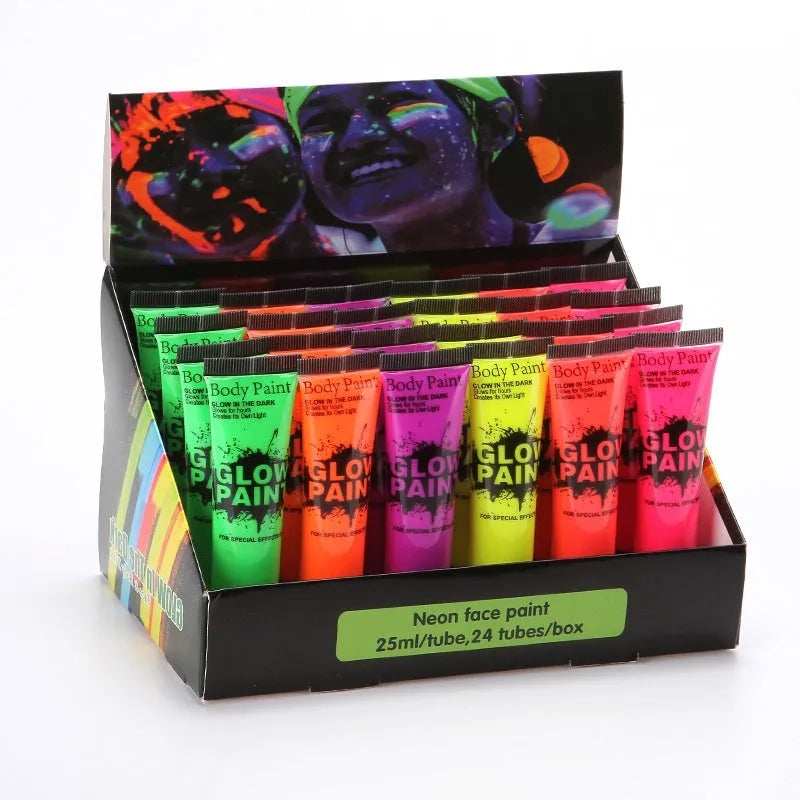 Close-up of a neon green face paint tube with hose applicator on a colourful design.