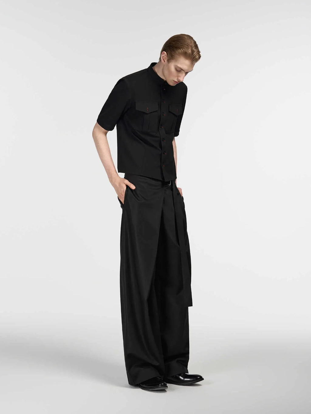Black straight-leg trousers with an adjustable waistband and a single pleat detail.