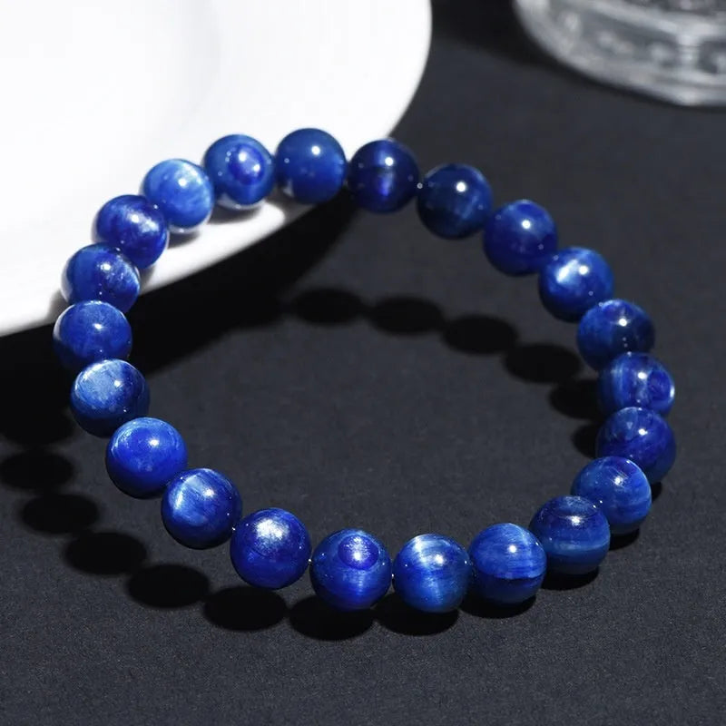 Natural blue crystal bead bracelet with geometric design and polished finish on a wrist.