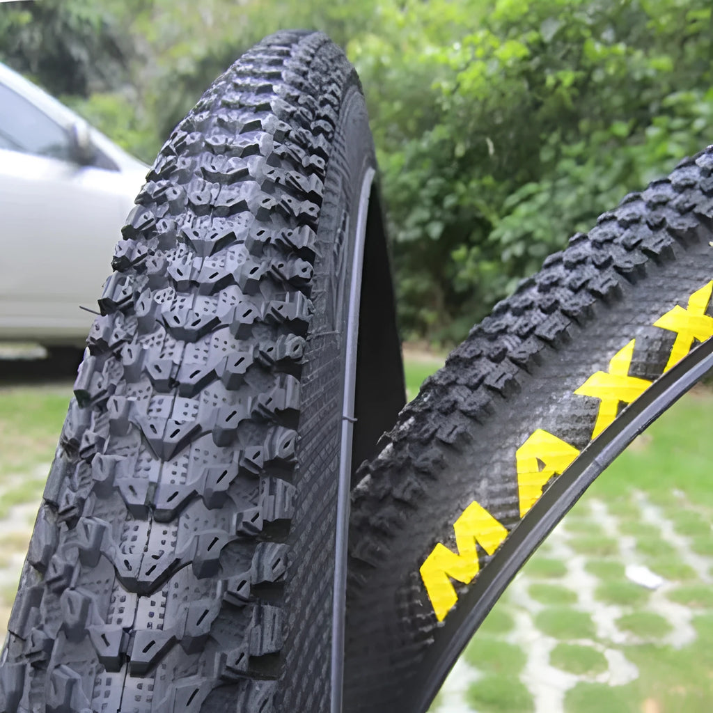 Ultralight black mountain bike tyre with puncture proof tread, shown in 26, 27.5 and 29 inch sizes.