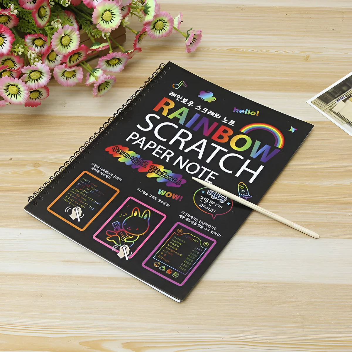 Large sheet of black scratch art paper for children, with a colourful revealed pattern showing through scraped areas.